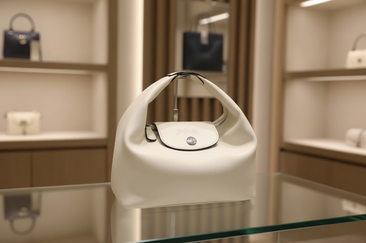 Modern oval  handheld bag with a clean, structured silhouette. Compact, elegant, and ideal for everyday use.