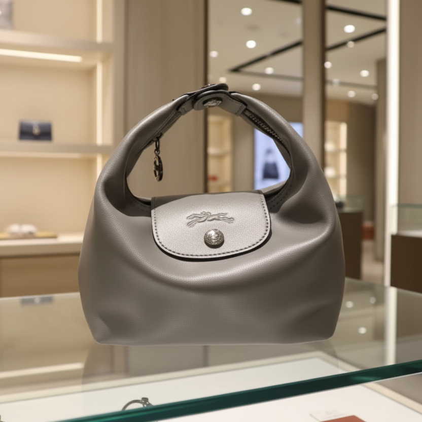 Modern oval  handheld bag with a clean, structured silhouette. Compact, elegant, and ideal for everyday use.
