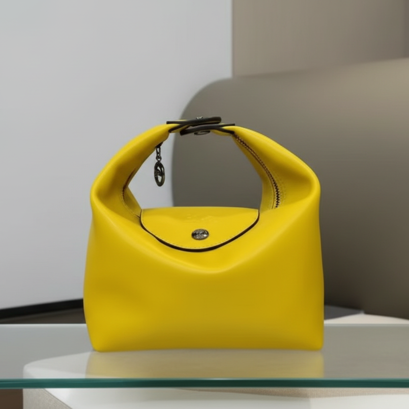 Modern oval  handheld bag with a clean, structured silhouette. Compact, elegant, and ideal for everyday use.